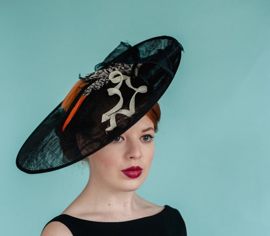 Ladies large navy sinamay fascinator with orange feathers ivory trim
