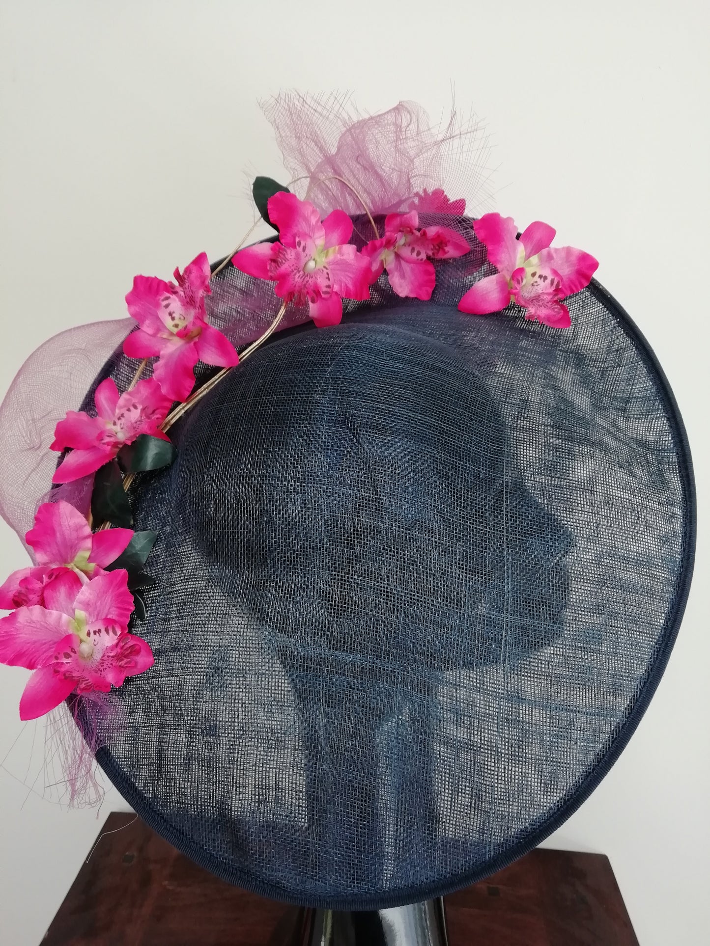 Large dark navy sinamay saucer hat with Fuschia  pink orchids